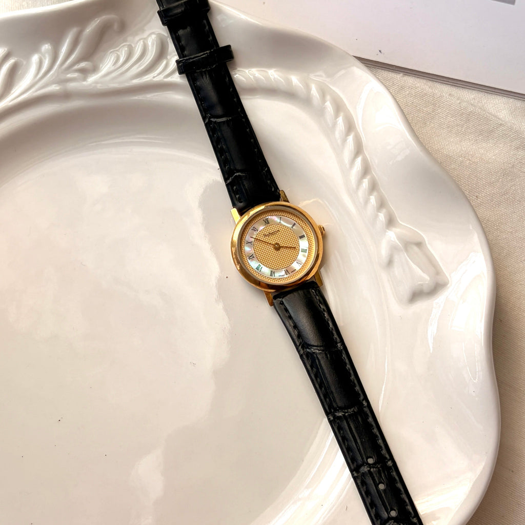 BRBY. Gold & MOP Round Dial Black Strap Watch