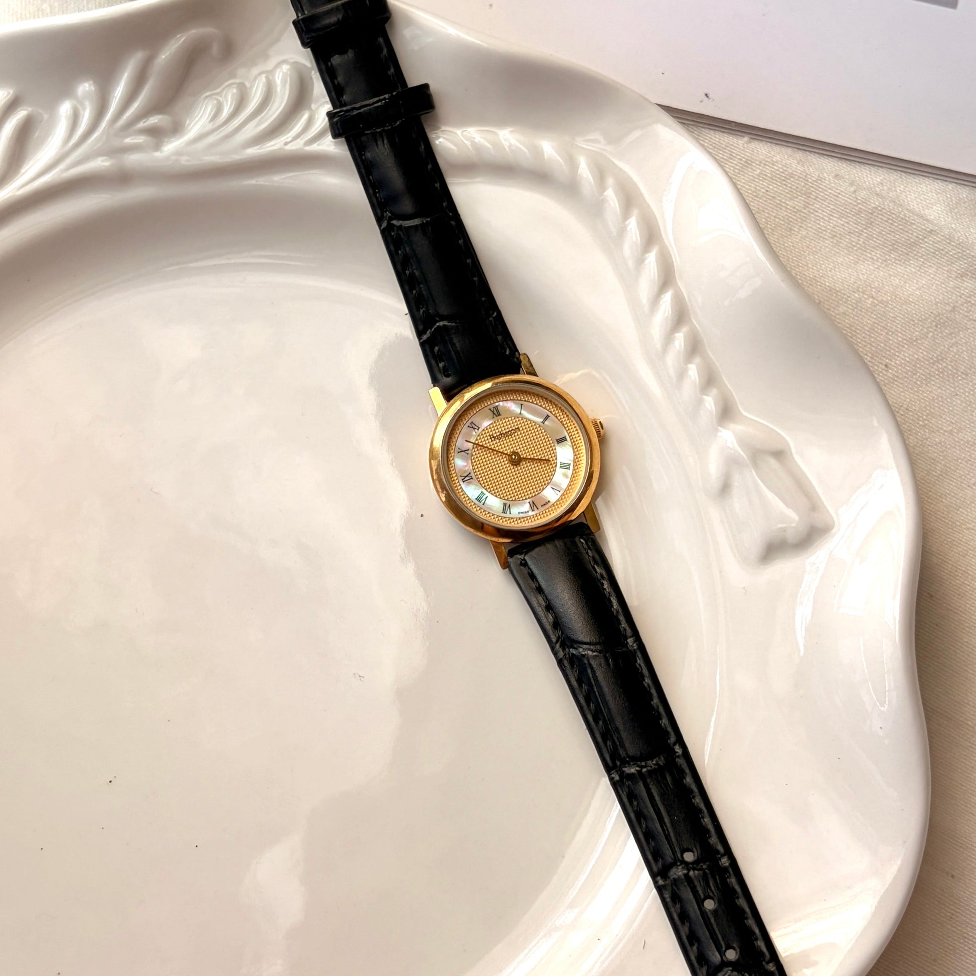 BRBY. Gold & MOP Round Dial Black Strap Watch