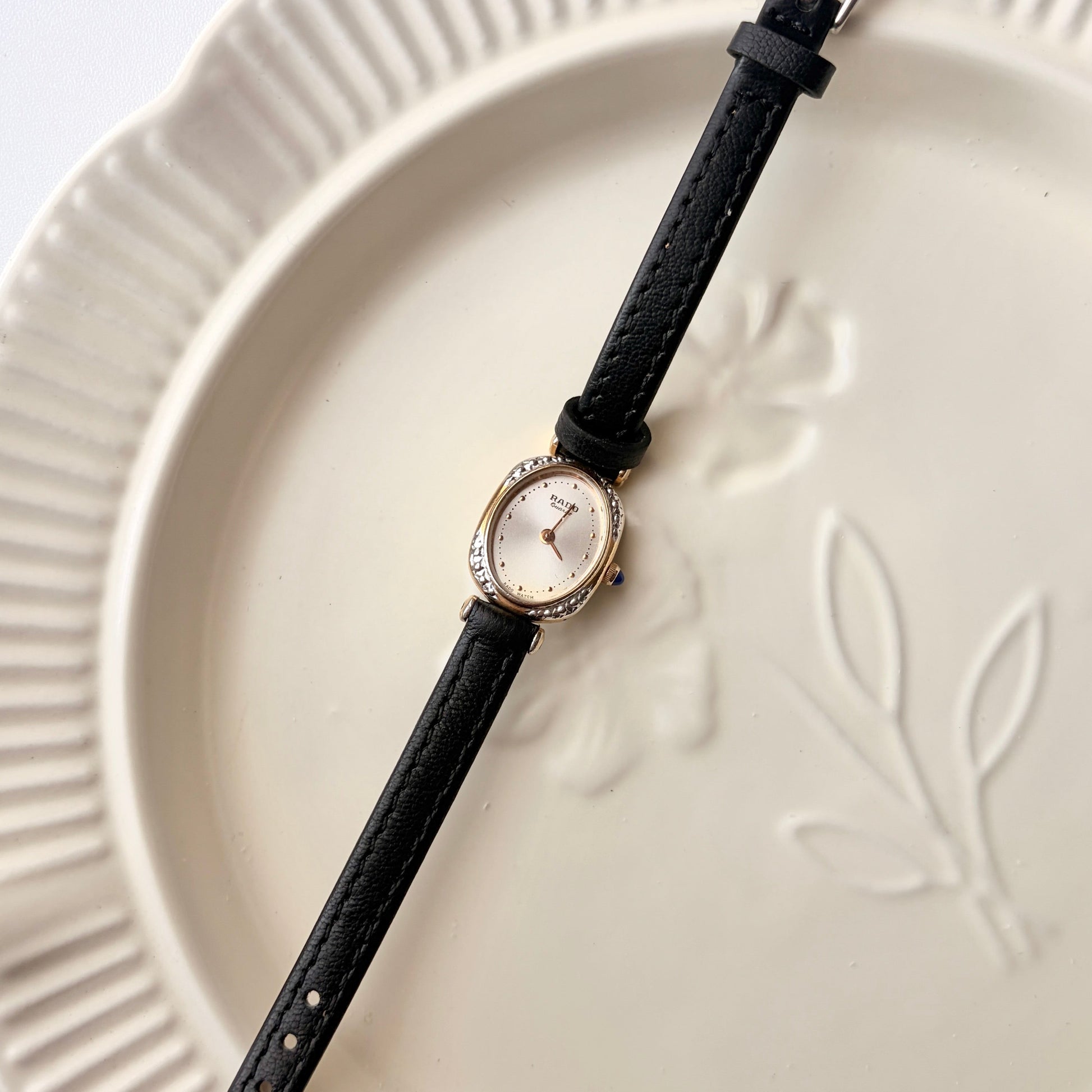 Rd. Gold Oval White Jewel Dial with Black Strap Watch