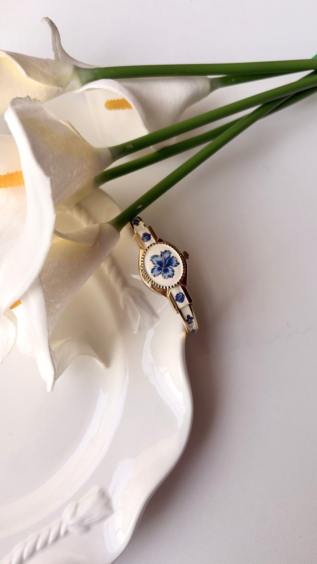 AM. White Blue Flower Case Gold Bangle Watch