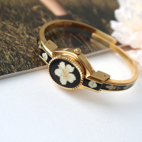 AM. White Hibiscus Flower Black Pattern Gold Bangle Watch
